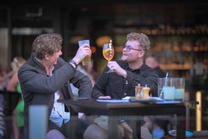 Cheers  two blokes drinking