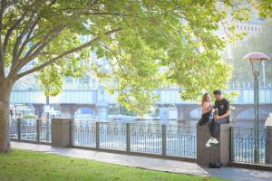 Couple under trees on promenade